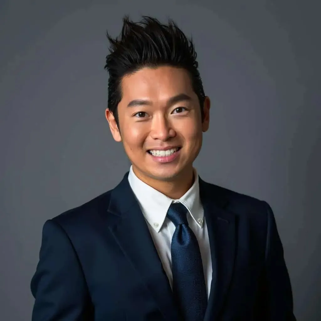 Portrait of James Yang in a navy suit and tie
