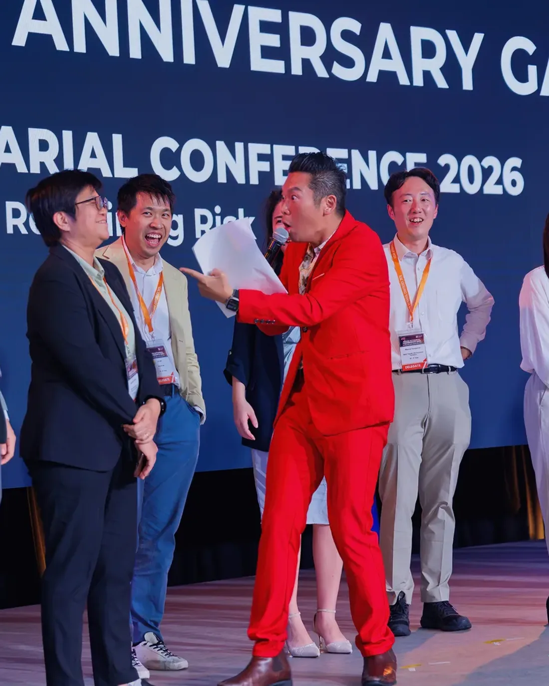 James Yang hosting a bilingual event in Singapore, speaking to guests at a banquet
