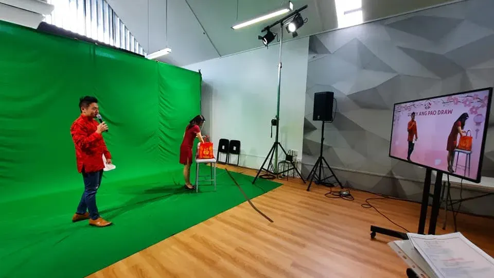 Green screen studio set up for a livestreamed virtual event, camera and lighting in position